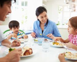 A family eats together at a table.